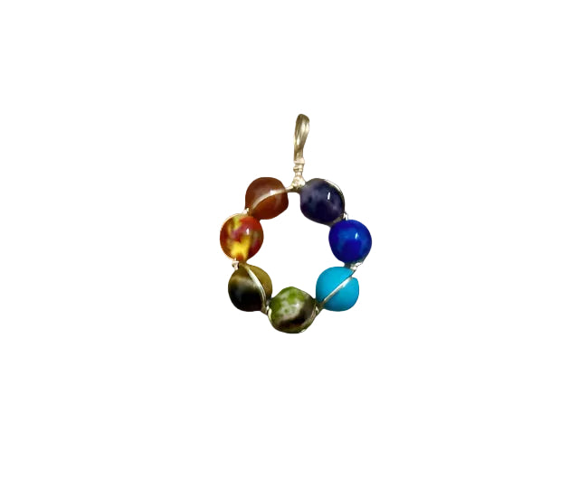 A multicolored round chakra pendant made of various stones, including red, orange, yellow, blue, purple, and green, set in a gold wire frame.