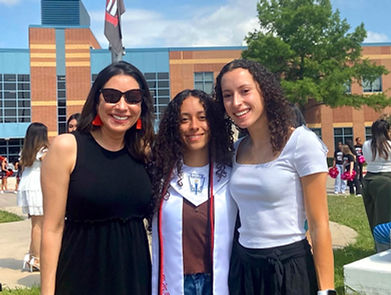 Bernadette, founder of My Silver Linings, smiling with her daughters at at graduation.