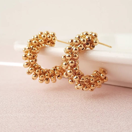18k gold-filled hoops featuring intricate clustered detailing  by Alejandra Parra.
