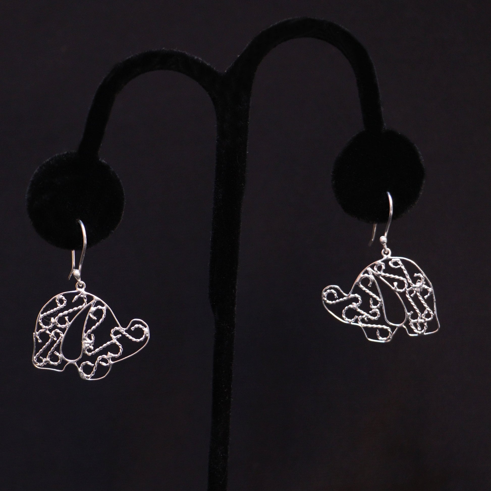 Sterling silver elephant earrings on a black handmade artisan jewelry Mexico.