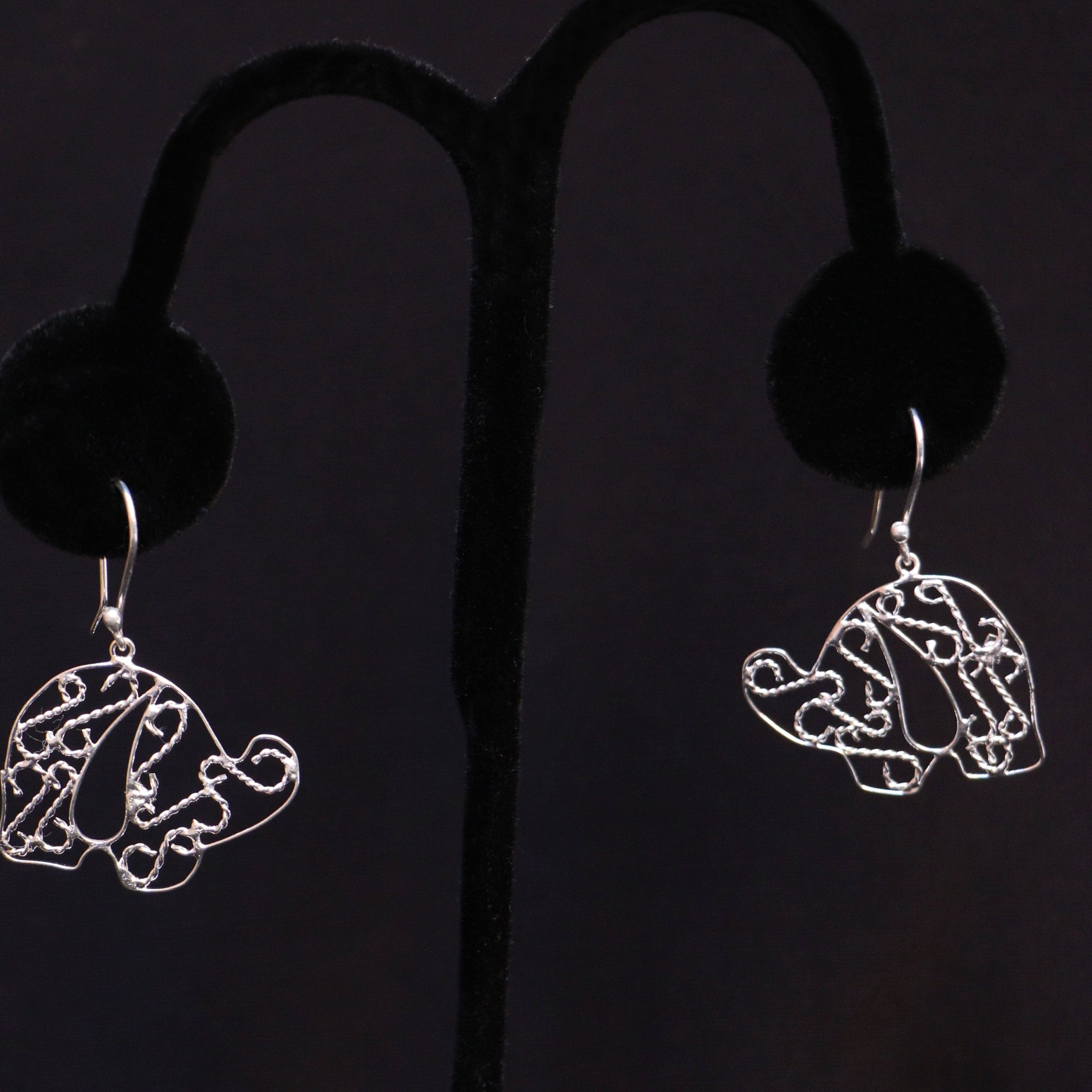 Sterling silver elephant earrings on a black handmade artisan jewelry Mexico.