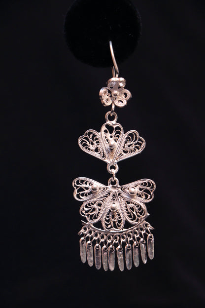 Handmade sterling silver chandelier earrings featuring intricate Mexican filigree scrollwork.