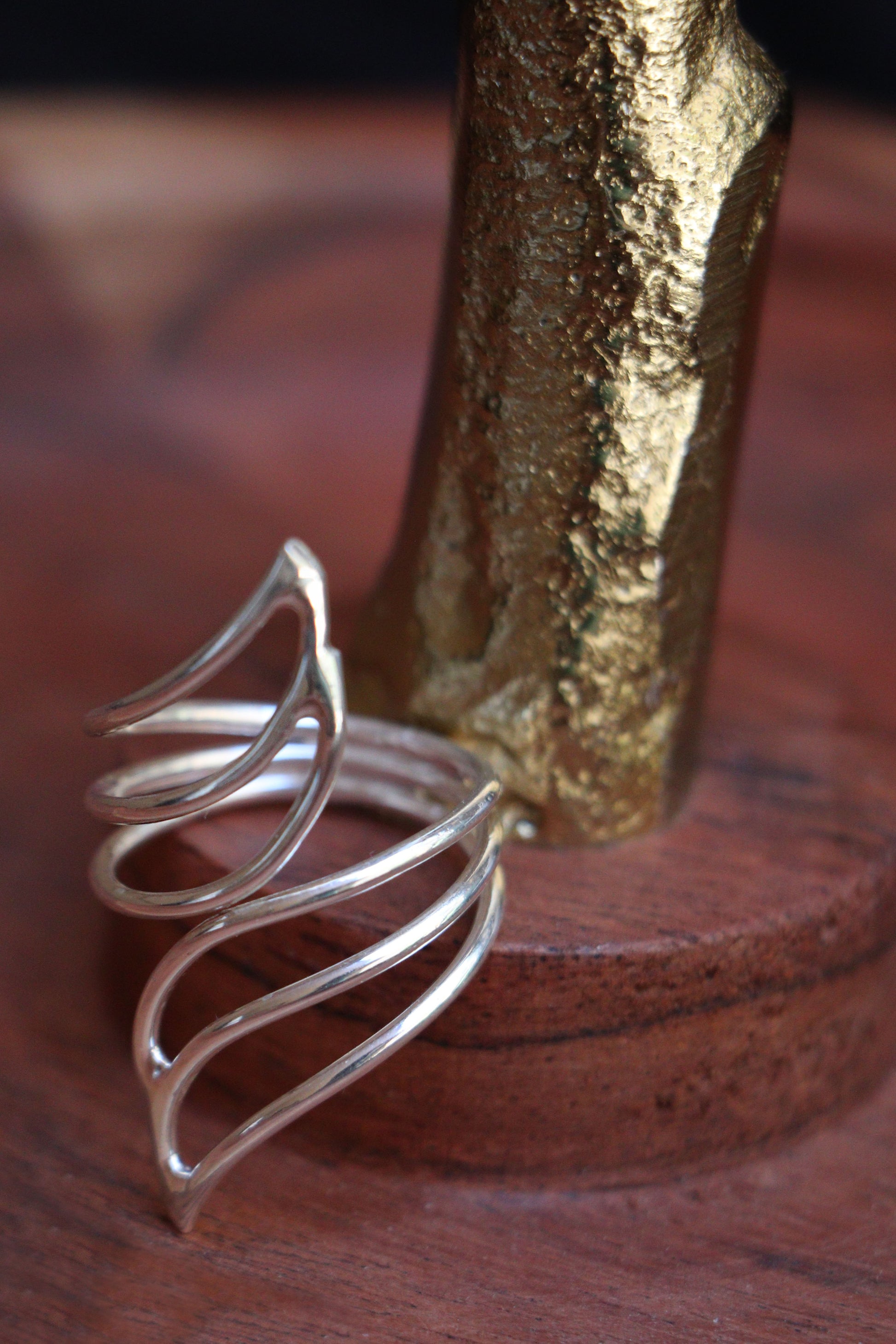 Handmade sterling silver adjustable ring featuring a modern open swirl design