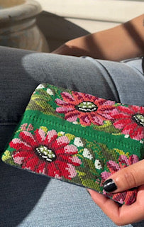 Green floral handwoven zipper pouch handmade in Guatemala from colorful upcycled textiles.