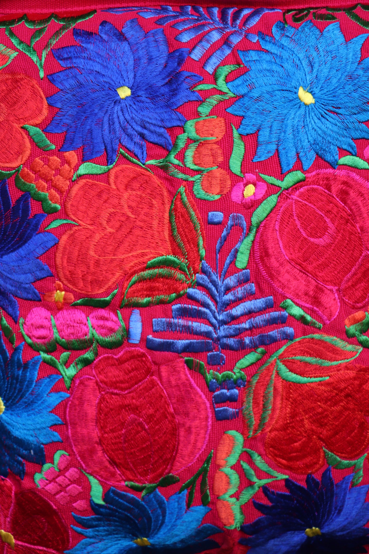 Handmade embroidered pillowcase featuring colorful artisan embroidery from Mexico.