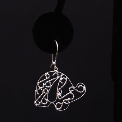 A pair of sterling silver elephant earrings, intricately handmade, displayed against a dark background.