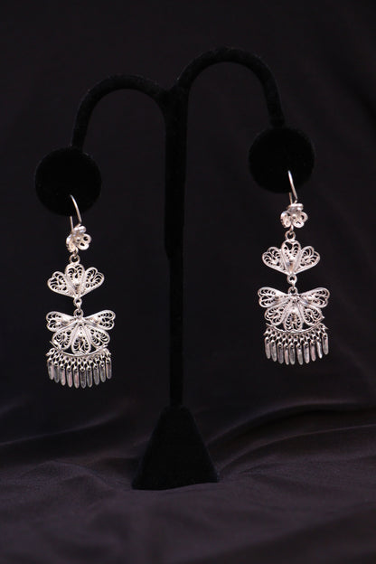 Pair of handmade sterling silver chandelier earrings featuring intricate Mexican filigree scrollwork.